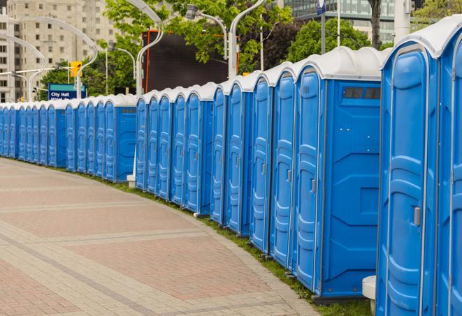 a row of portable restrooms at an outdoor special event, ready for use in Beacon Falls